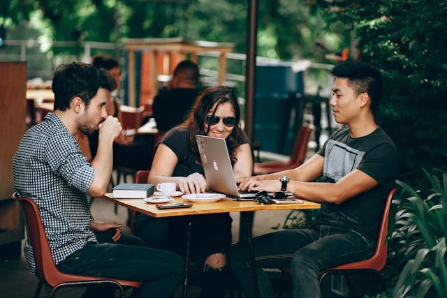 3 digital nomads sur une terrasse de café